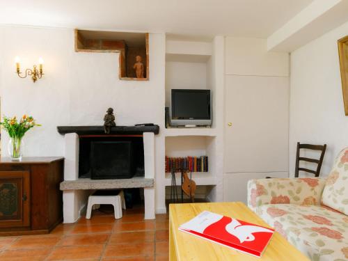 a living room with a couch and a fireplace at Apartment Villaggio Sureggio A6 mit TicinoTicket by Interhome in Lugaggia