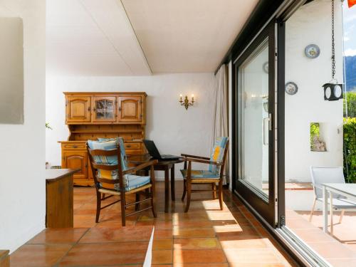 a dining room with a table and chairs at Apartment Villaggio Sureggio A6 mit TicinoTicket by Interhome in Lugaggia