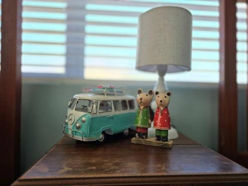 two hello kitty figurines next to a toy van on a table at Fijnbos in Pringle Bay