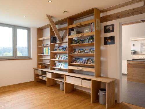 a room with a book shelf with books at Apartment Altes Zollhaus-3 by Interhome in Fischbach bei Dahn