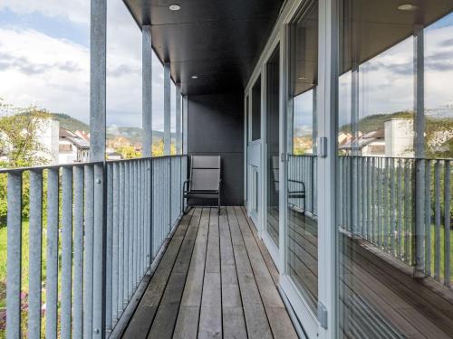 a balcony of a house with windows and a chair at Apartment Altes Zollhaus-3 by Interhome in Fischbach bei Dahn