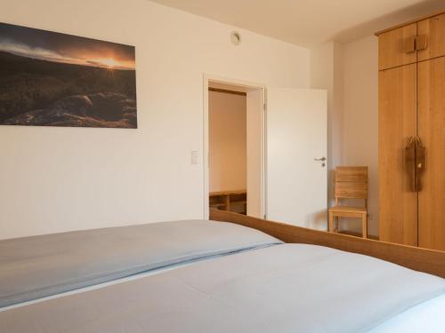 a bedroom with a bed and a painting on the wall at Apartment Altes Zollhaus-2 by Interhome in Fischbach bei Dahn