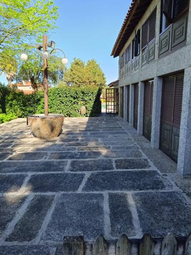 a stone walkway next to a building with a pole at Quinta do Carvalho - Nature Guest Houses in Guimarães