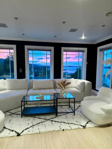 a living room with a white couch and a table at Villa Freya with stunning sea view in Kristiansund