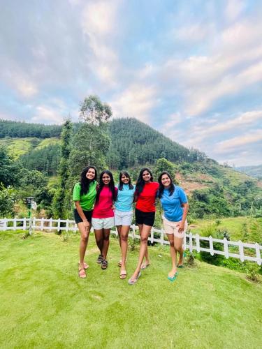 a group of women standing in front of a fence at Jayawardane’s Bungalow in Mandaramnuwara in Mandaran Newara
