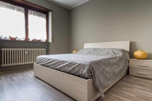 a bedroom with a bed in a room with a window at Cardinal massaia venice apartment in Mestre