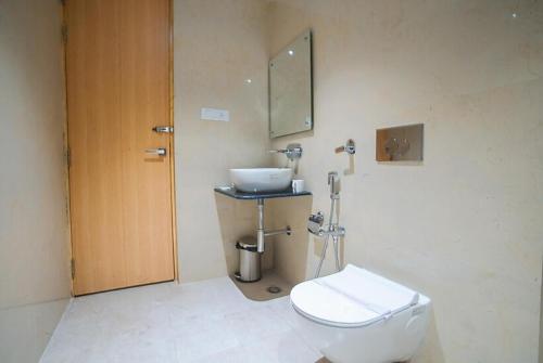 a bathroom with a toilet and a sink at Hotel Classic in Lucknow