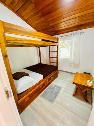 a small bedroom with a bunk bed and a table at Jayawardane’s Bungalow in Mandaramnuwara in Mandaran Newara