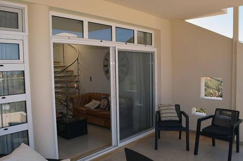 a living room with a sliding glass door with a couch at Luxury house Makry gialos 200m to the beach 6 pers in Makry Gialos
