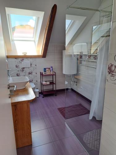 a bathroom with a sink and a window at Apartmaji Magda in Zgornje Gorje