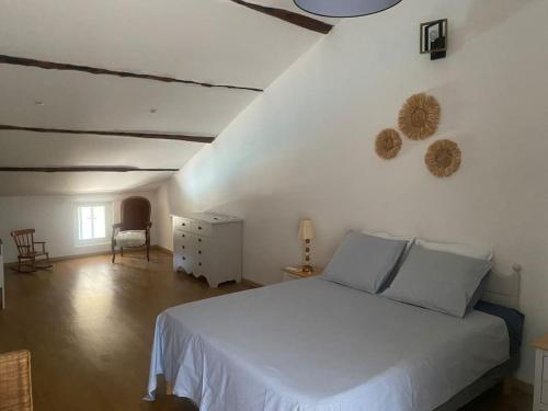 une chambre avec un lit blanc dans une pièce dans l'établissement Mas avec piscine entre Alpilles et Luberon, à Sénas