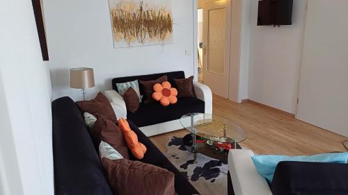 a living room with a couch and a glass table at Ferienwohnungen Stadler in Rödental