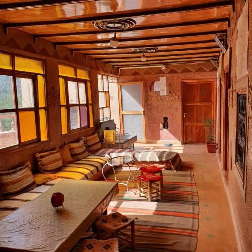 a living room with a couch and a table at Gite Tawada in Aït Imi
