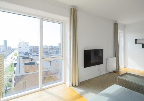 Телевизор и/или развлекательный центр в Luxurios 3-bed w balcony and great views