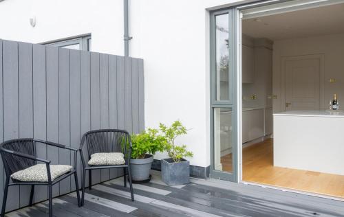 two chairs sitting on a balcony with a counter at GuestReady - Amazing house in Sandymount in Dublin