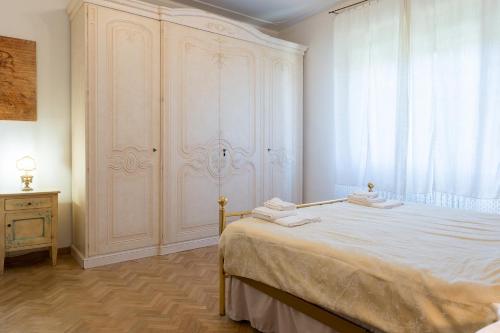 a bedroom with a large bed with towels on it at Art Rooms in Arezzo