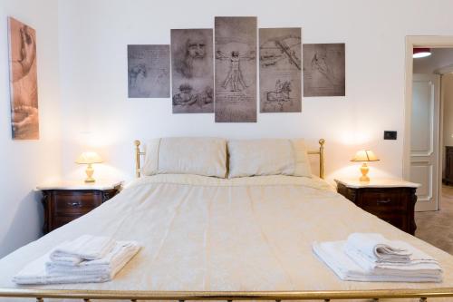 a bedroom with a large bed with two night stands at Art Rooms in Arezzo