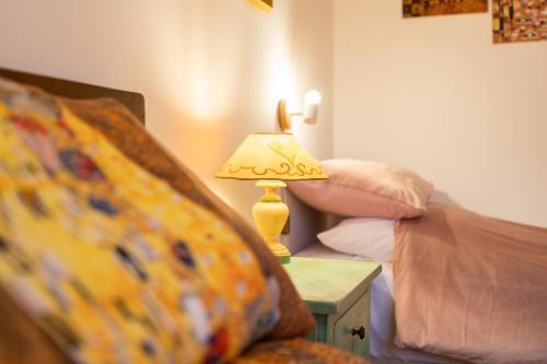 a lamp sitting on a table next to a bed at Art Rooms in Arezzo