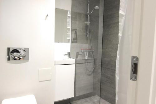 a bathroom with a shower with a toilet and a sink at Wonderful 2-bed wbalcony in top Frederiksberg location in Copenhagen