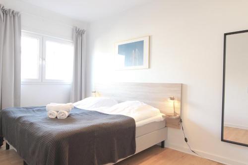a bedroom with a bed with two towels on it at Wonderful 2-bed wbalcony in top Frederiksberg location in Copenhagen