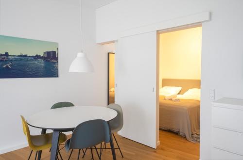 a room with a table and chairs and a bed at Private Townhouse w terrace in Aarhus