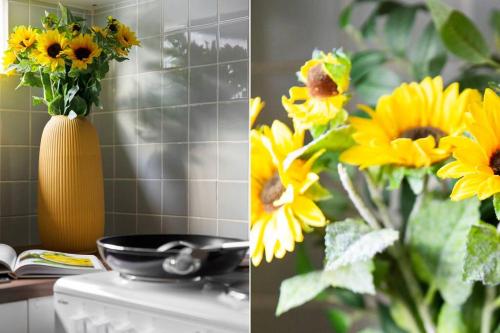 a vase filled with yellow flowers on top of a stove at South Yarra Urban Haven in Melbourne