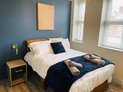 a bedroom with a bed with towels on it at Brantwood Apartments - Apartment 2 in Manchester