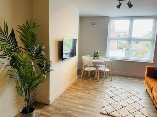 a living room with a couch and a dining room table at Brantwood Apartments - Apartment 2 in Manchester