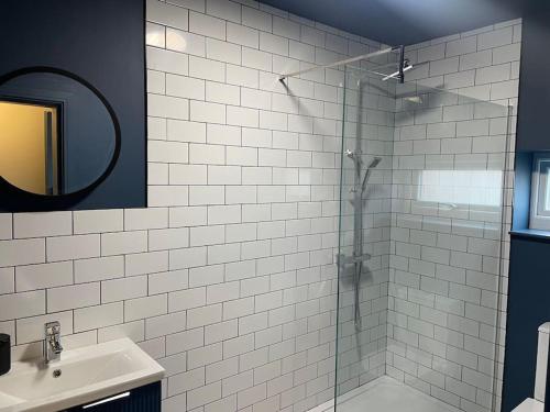 a bathroom with a glass shower and a sink at Brantwood Apartments - Apartment 2 in Manchester