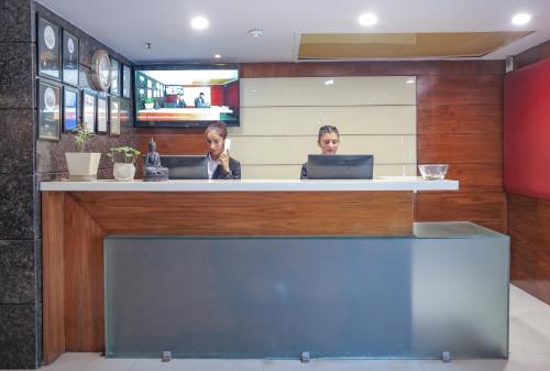 two people sitting at a counter in a restaurant at Hotel Cama in Chandīgarh