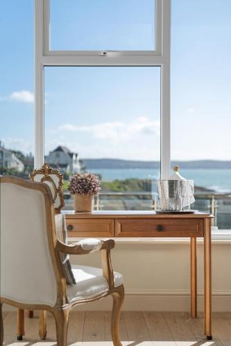 a desk and a chair in front of a window at Watersmeet Hotel in Woolacombe