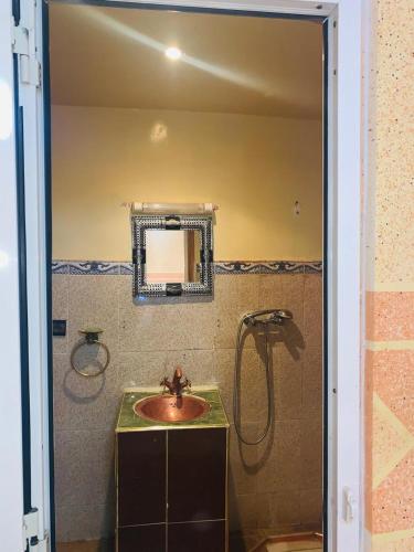 a bathroom with a sink and a shower at Gite Tawada in Aït Imi