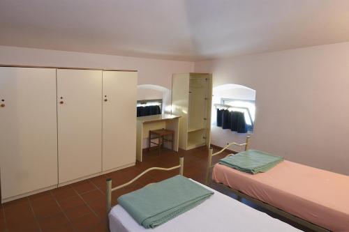 Katil atau katil-katil dalam bilik di Ostello Palazzo Pierantoni