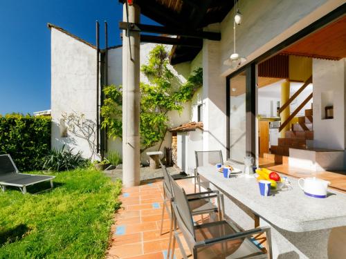 an outdoor dining area with a table and chairs at Apartment Villaggio Sureggio A7 mit TicinoTicket by Interhome in Lugaggia