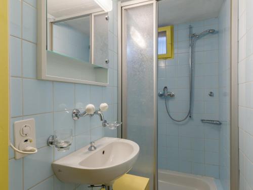 a bathroom with a sink and a shower at Apartment Villaggio Sureggio A7 mit TicinoTicket by Interhome in Lugaggia