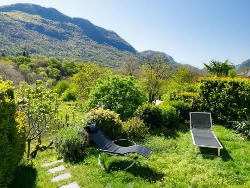 a chair and a laptop sitting in the grass at Apartment Villaggio Sureggio A7 mit TicinoTicket by Interhome in Lugaggia