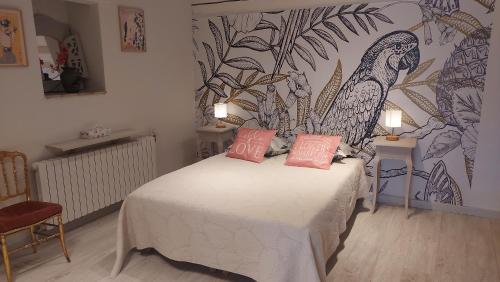 a bedroom with a bed with two pink pillows on it at La Bombonière & Spa in Roquebrune-Cap-Martin