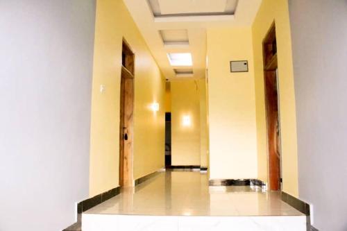 an empty hallway with two doors in a building at Latitude Lukozi Hotel in Hambayo