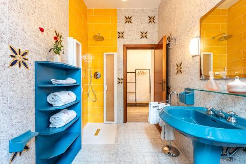 a bathroom with a blue sink and a mirror at Vertine Countryside in Gaiole in Chianti