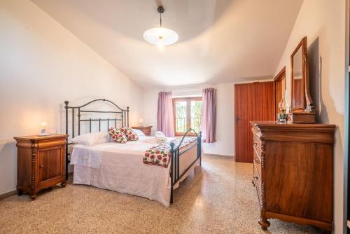 a bedroom with a bed and two night stands at Vertine Countryside in Gaiole in Chianti