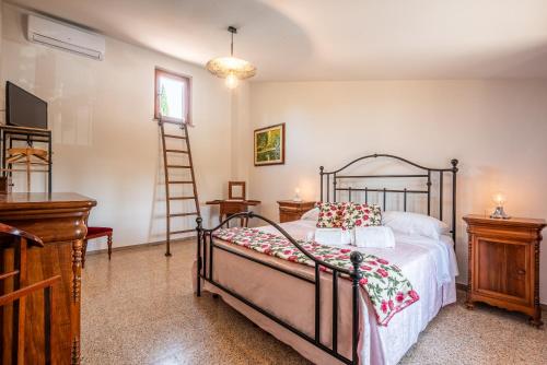 a bedroom with a bed and a ladder in it at Vertine Countryside in Gaiole in Chianti