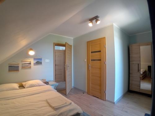 sypialnia z dużym łóżkiem i szafą w obiekcie Pokoje gościnne Słoneczny Klon Dąbrówno w mieście Dąbrówno