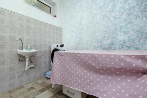 a bathroom with a pink bed and a sink at DERON Apartments in Ulcinj