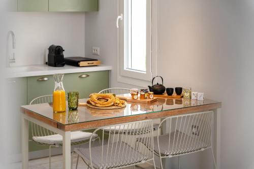 a kitchen with a table with some food on it at Sunday Luxury Suites in Agia Anna Naxos