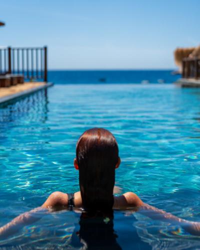a person in the water in a swimming pool at Sea Valley Lodge in Faralya