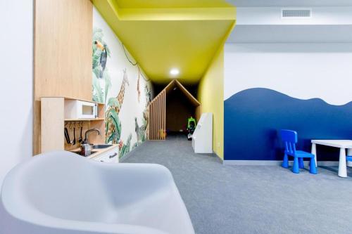 een kamer met een keuken met een tafel en blauwe stoelen bij Rewal Cliff Morska 1 in Rewal