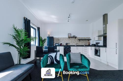 a living room with two chairs and a kitchen at 25 percent OFF Monthly Stay By NYOS PROPERTIES Short Lets & Serviced Accommodation Manchester Business Leisure in Manchester