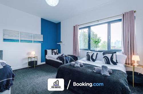 a bedroom with two beds and a large window at 25 percent OFF Monthly Stay By NYOS PROPERTIES Short Lets & Serviced Accommodation Manchester Business Leisure in Manchester