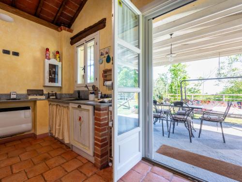 a kitchen with a sliding glass door leading to a patio at Holiday Home Il Valletto by Interhome in Mombaruzzo