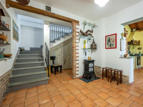 a living room with a staircase and a fireplace at Holiday Home Il Valletto by Interhome in Mombaruzzo